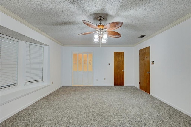 empty room featuring carpet flooring, ceiling fan, ornamental molding, and a textured ceiling