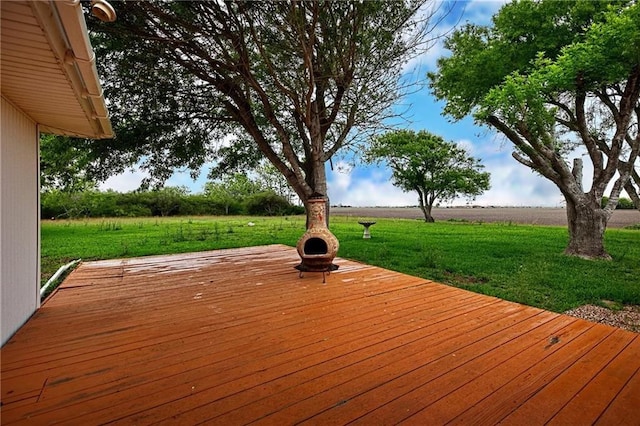 deck featuring a rural view and a yard