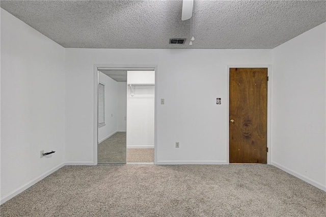 unfurnished room featuring carpet floors and a textured ceiling