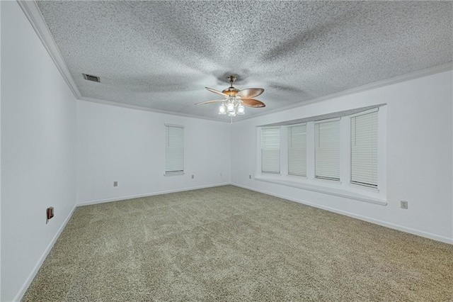 carpeted empty room featuring a textured ceiling, ceiling fan, and ornamental molding