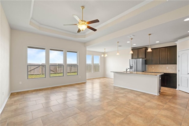 1733 Rhumba Trl, Corpus Christi, TX 78410 - kitchen with stainless steel refrigerator with ice dispenser, backsplash, ceiling fan, open floor plan, and dark brown cabinets
