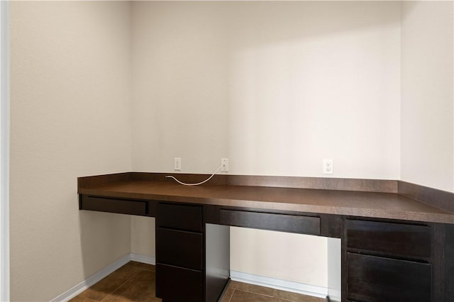 1733 Rhumba Trl, Corpus Christi, TX 78410 - unfurnished office featuring built in desk, dark tile patterned flooring, and baseboards