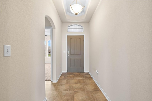 1733 Rhumba Trl, Corpus Christi, TX 78410 - doorway featuring arched walkways, baseboards, and a tray ceiling
