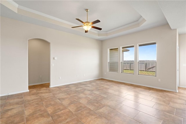 1733 Rhumba Trl, Corpus Christi, TX 78410 - empty room with a tray ceiling, a ceiling fan, arched walkways, ornamental molding, and baseboards