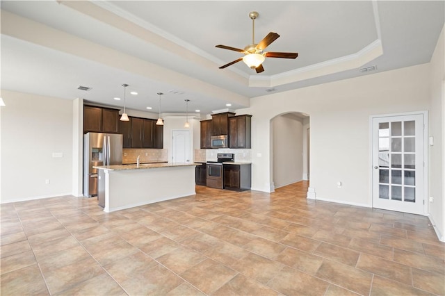 1733 Rhumba Trl, Corpus Christi, TX 78410 - kitchen featuring stainless steel appliances, arched walkways, open floor plan, a ceiling fan, and tasteful backsplash