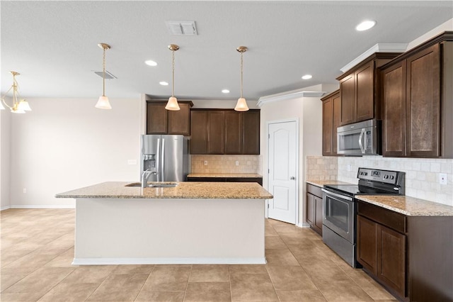 1733 Rhumba Trl, Corpus Christi, TX 78410 - kitchen featuring stainless steel appliances, a sink, dark brown cabinetry, an island with sink, and recessed lighting
