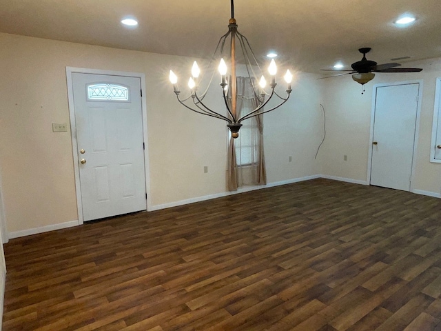 foyer featuring ceiling fan with notable chandelier and dark hardwood / wood-style flooring