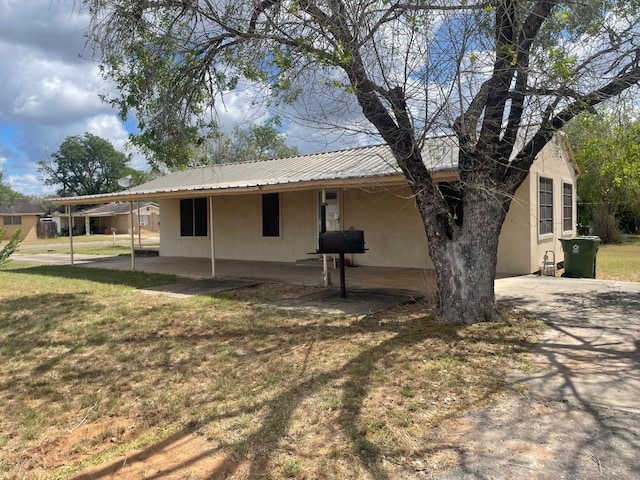 back of house with a lawn