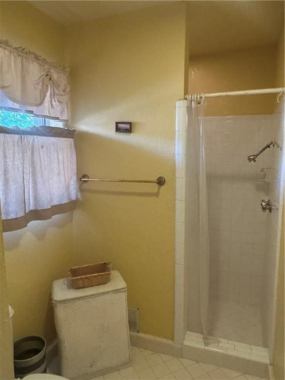 6026 Killarmet, Corpus Christi, TX 78413 - bathroom with a shower stall, tile patterned flooring, and baseboards