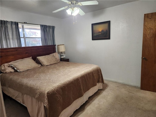 bedroom featuring light colored carpet and ceiling fan