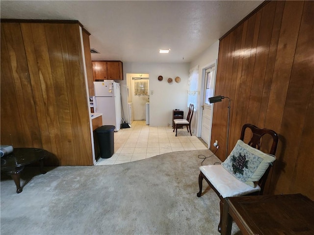 sitting room featuring wood walls and light tile patterned flooring