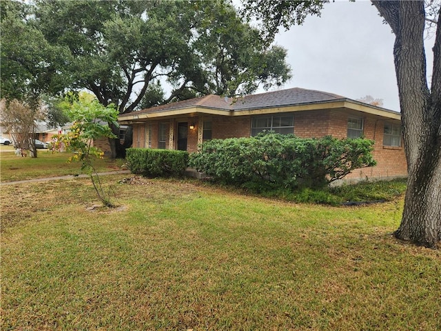 view of side of home with a lawn