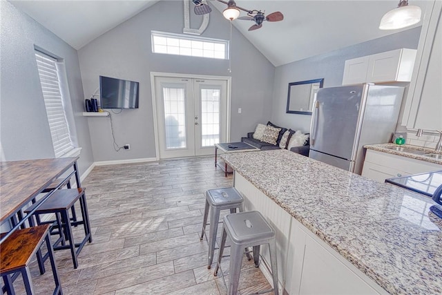 4601 Gulfbreeze Blvd Unit 1, 2, 3, 4, 5, Corpus Christi, TX 78402 - kitchen featuring stainless steel refrigerator, ceiling fan, french doors, sink, and white cabinets