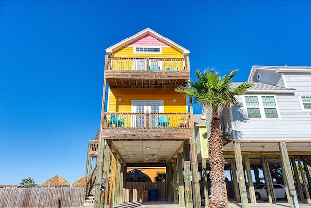 view of front of home featuring a carport and a balcony