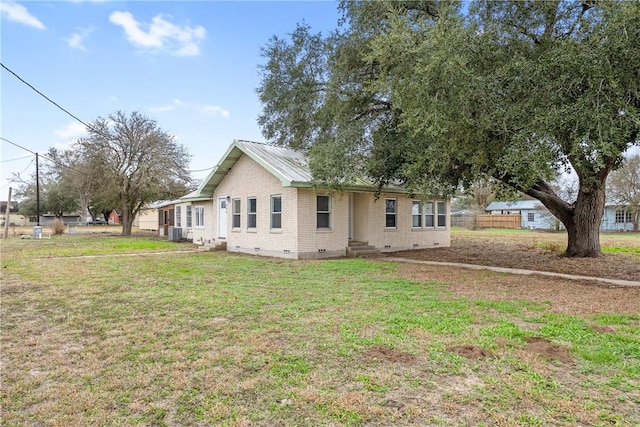 view of front of home featuring central AC unit and a front lawn