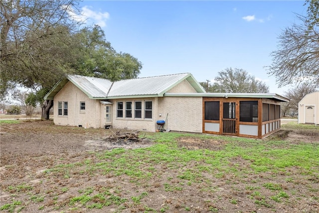 rear view of property with a sunroom