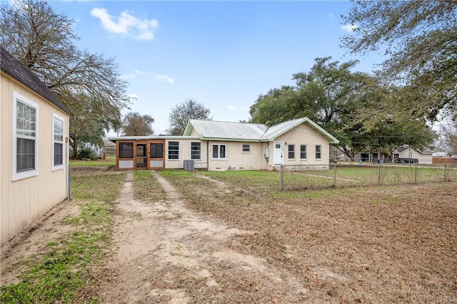 view of front facade with central AC unit and a sunroom