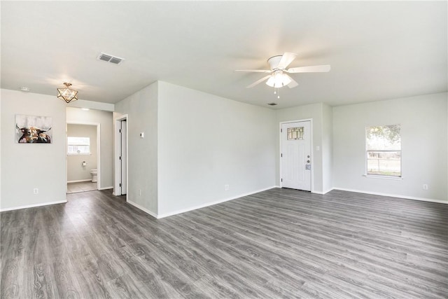 spare room featuring plenty of natural light, dark hardwood / wood-style floors, and ceiling fan