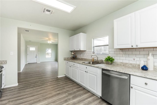 kitchen with sink, light hardwood / wood-style flooring, appliances with stainless steel finishes, tasteful backsplash, and white cabinets