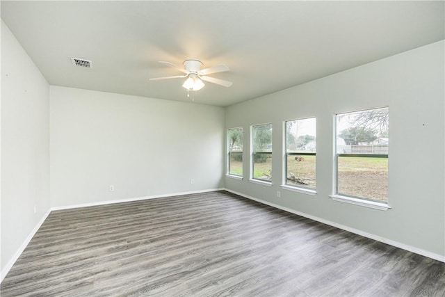 spare room featuring ceiling fan and dark hardwood / wood-style floors