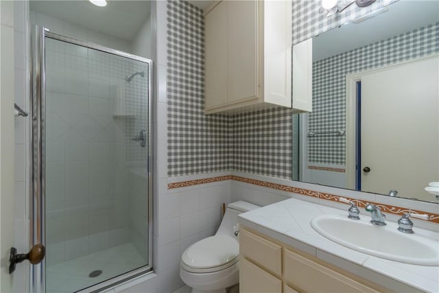 bathroom with vanity, a shower with shower door, and toilet