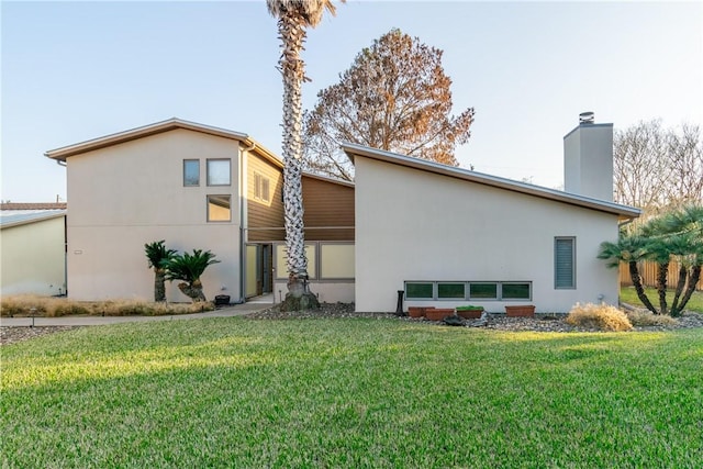 rear view of house with a yard