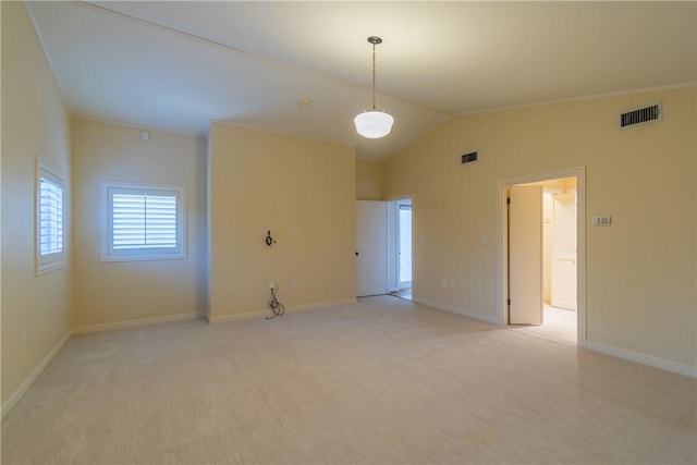 carpeted empty room with vaulted ceiling