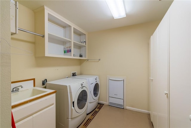 laundry room with separate washer and dryer and sink