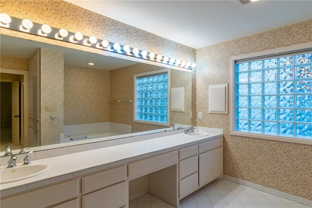 bathroom featuring tile patterned flooring, vanity, and a bath