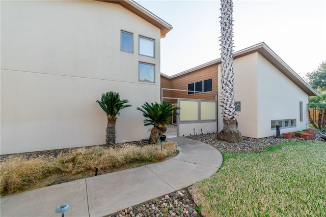 view of side of property with a lawn