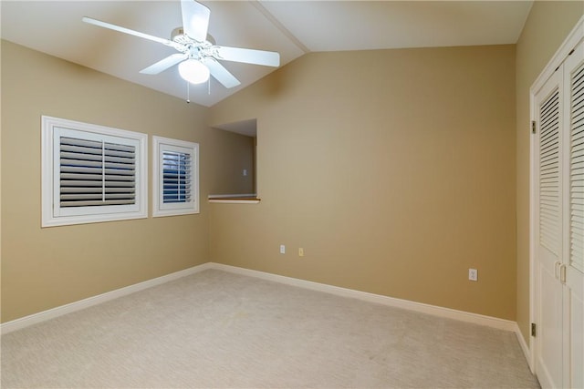 unfurnished bedroom with light carpet, lofted ceiling, a closet, and ceiling fan