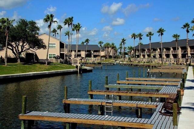view of dock with a residential view and a water view