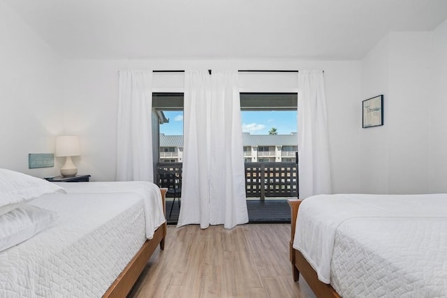 bedroom featuring light wood finished floors and access to outside