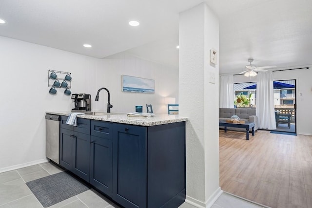 kitchen featuring a sink, baseboards, dishwasher, a peninsula, and a ceiling fan