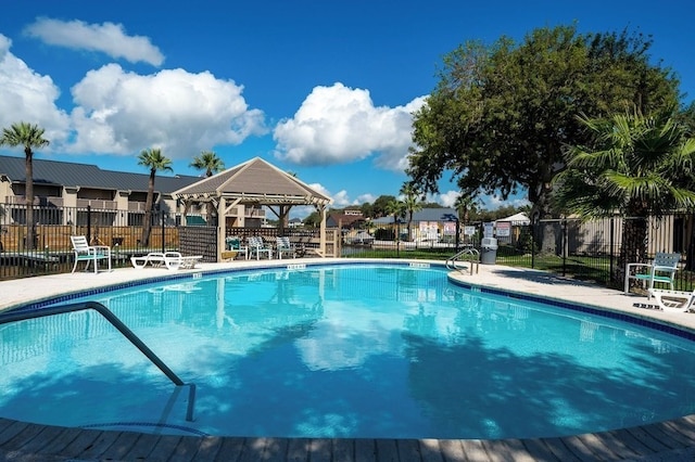 pool with a gazebo and fence