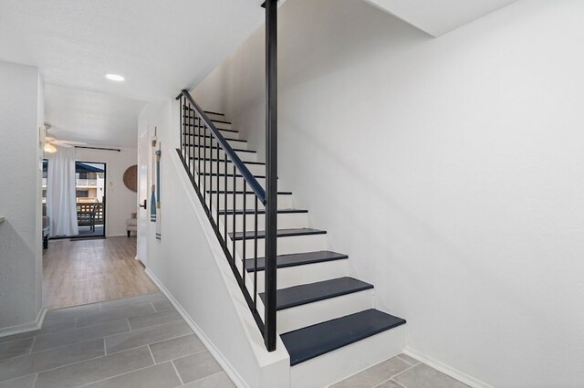 staircase with a ceiling fan, tile patterned flooring, recessed lighting, and baseboards
