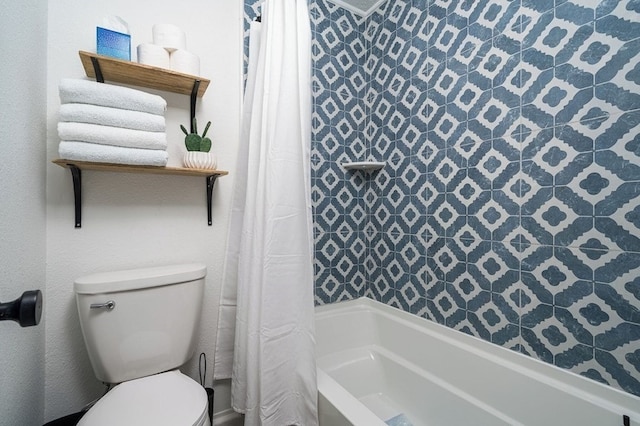bathroom featuring toilet and shower / bath combination with curtain