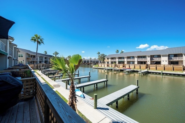 dock area with a residential view and a water view