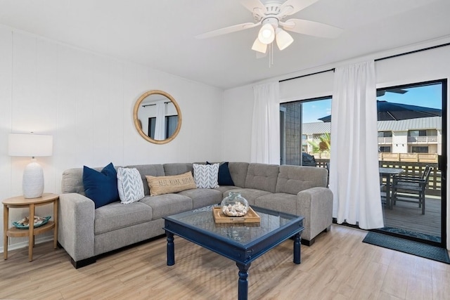 living room with a ceiling fan and light wood-style floors