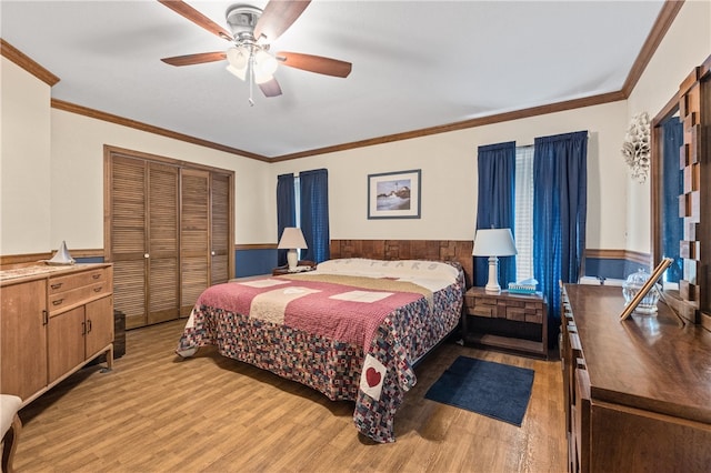 bedroom with a closet, ceiling fan, light hardwood / wood-style flooring, and crown molding