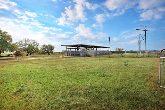 view of yard with a rural view and an outdoor structure