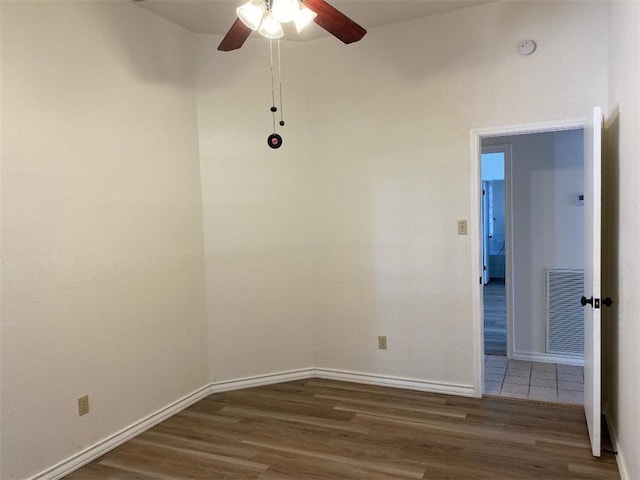 empty room with ceiling fan and dark hardwood / wood-style floors