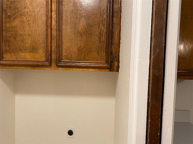 laundry room featuring cabinets and electric dryer hookup