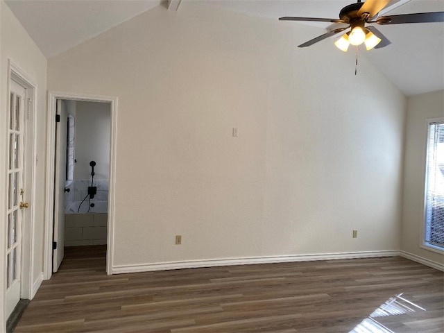 spare room with dark hardwood / wood-style flooring, vaulted ceiling with beams, and ceiling fan