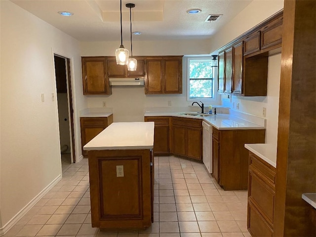 kitchen featuring light tile patterned flooring, a kitchen island, white dishwasher, pendant lighting, and sink