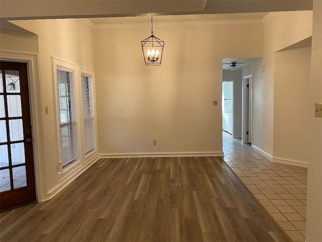 unfurnished dining area featuring ornamental molding, ceiling fan with notable chandelier, and dark hardwood / wood-style floors