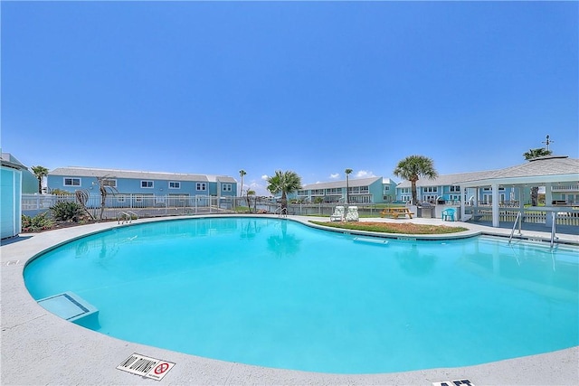 611 Lauderdale Dr, Rockport, TX 78382 - community pool featuring fence and a residential view