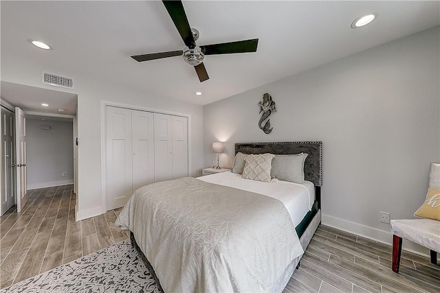 611 Lauderdale Dr, Rockport, TX 78382 - bedroom with wood tiled floors, baseboards, a closet, recessed lighting, and ceiling fan
