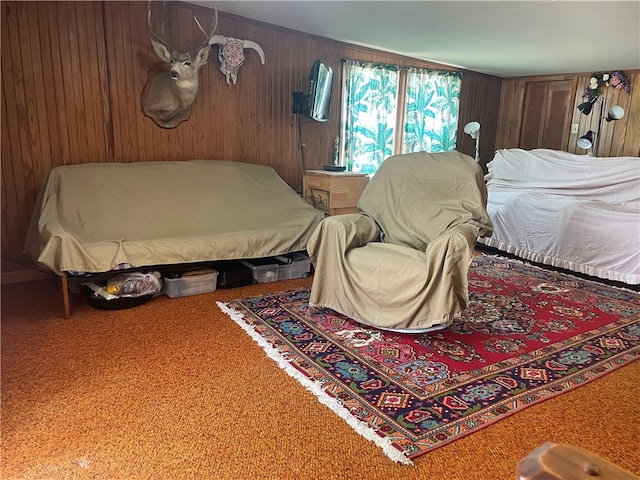 bedroom featuring wood walls and carpet floors