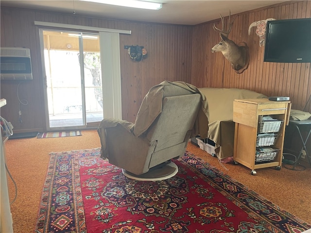 sitting room featuring a wall mounted AC and carpet floors